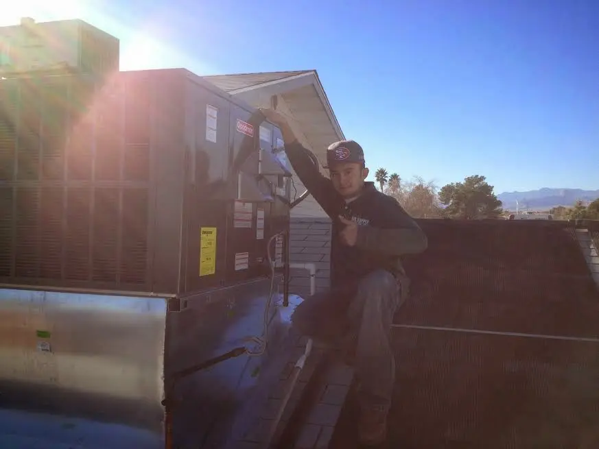 HVAC technician performing HVAC Inspection on a rooftop unit in Kaiminani